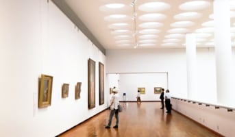 The gallery's circular ceiling arches over the upper viewing area. Designed by architect Hanz Lego.